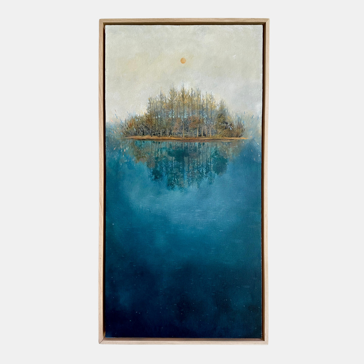 Framed artwork of a serene landscape with trees on an island in the middle of a blue body of water.