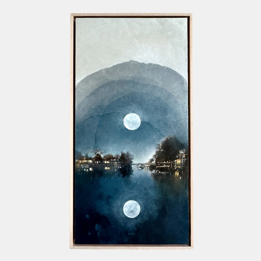 Framed artwork of a moonlit landscape with trees and a lake.